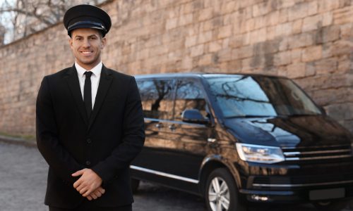 Professional driver near luxury car on street. Chauffeur service Professional driver near luxury car on street. Chauffeur service